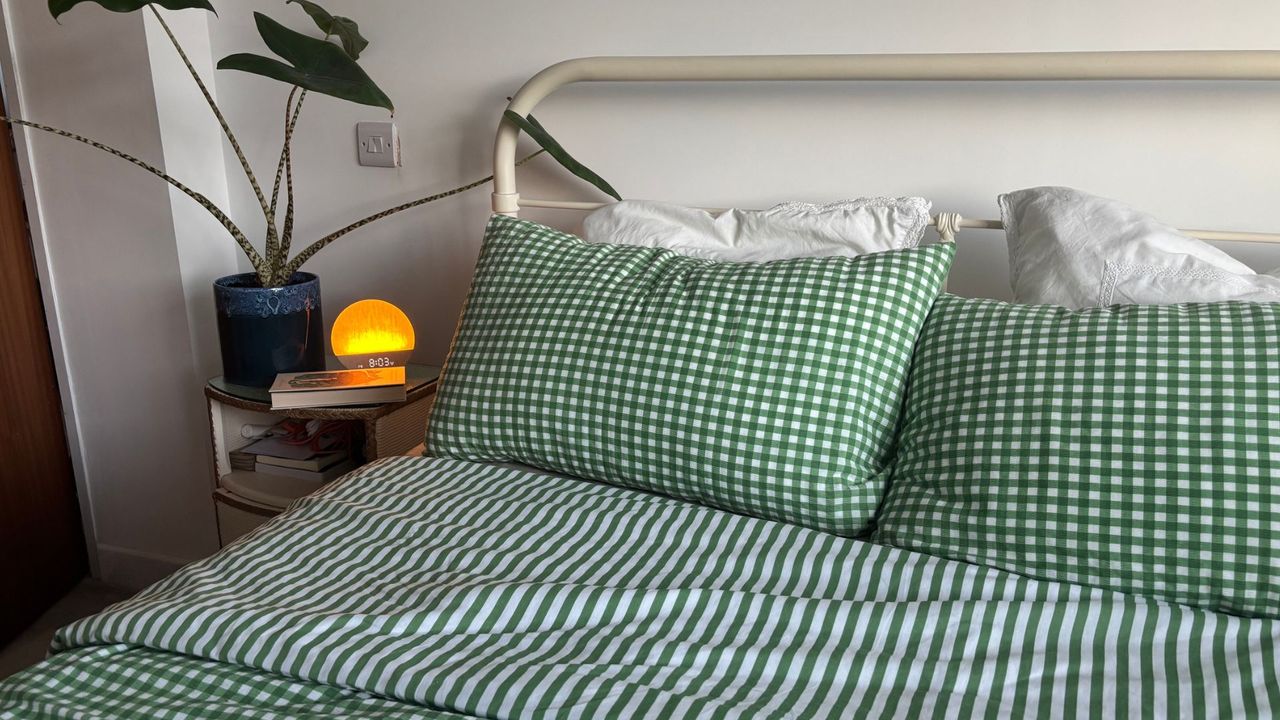 The image shows the Birch Elite Natural mattress dressed in green and white gingham bedding, placed inside a neutrally decorated bedroom