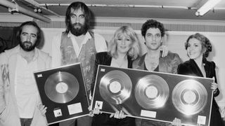 Fleetwood Mac with awards for British sales of their albums 'Rumours' and Tusk', Wembley Arena, London, June 1980. The band are backstage at one of six shows between 20th - 27th June. Left to right: John McVie, Mick Fleetwood, Christine McVie, Lindsey Buckingham and Stevie Nicks