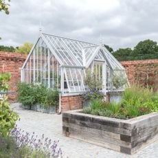 white greenhouse in walled garden