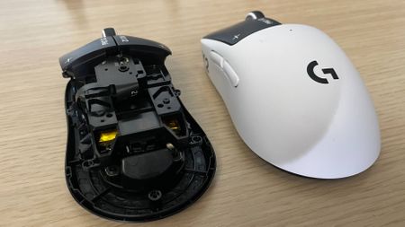 A Logitech G Pro X2 Superstrike gaming mouse next to a version of it with its shell off, showing its internals.