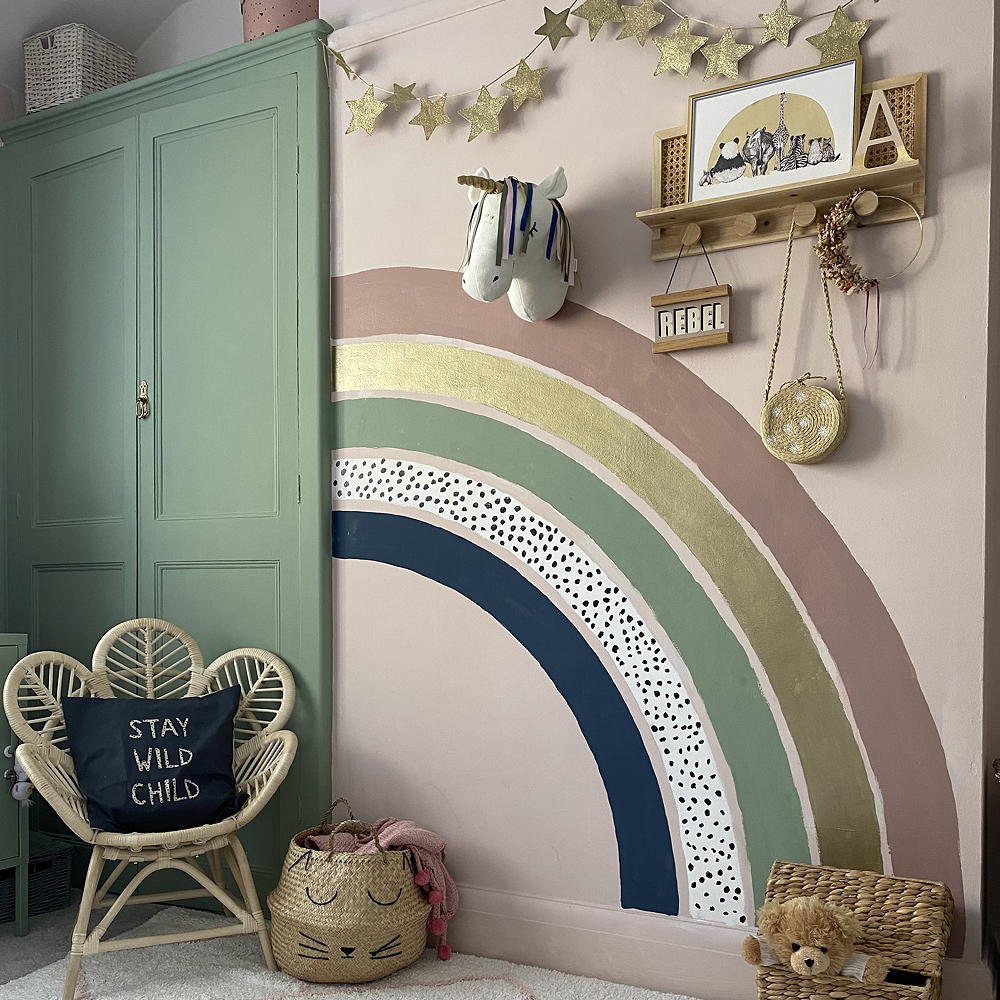 room with green door and rainbow printed wall