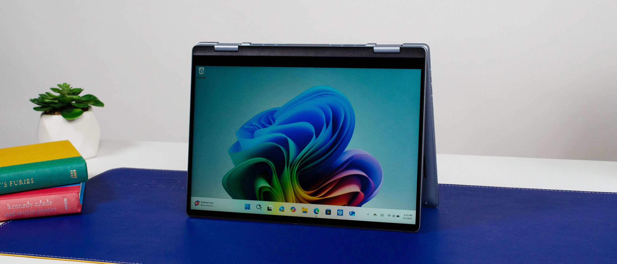 A Dell 14 Plus 2-in-1 in tent mode on a desk