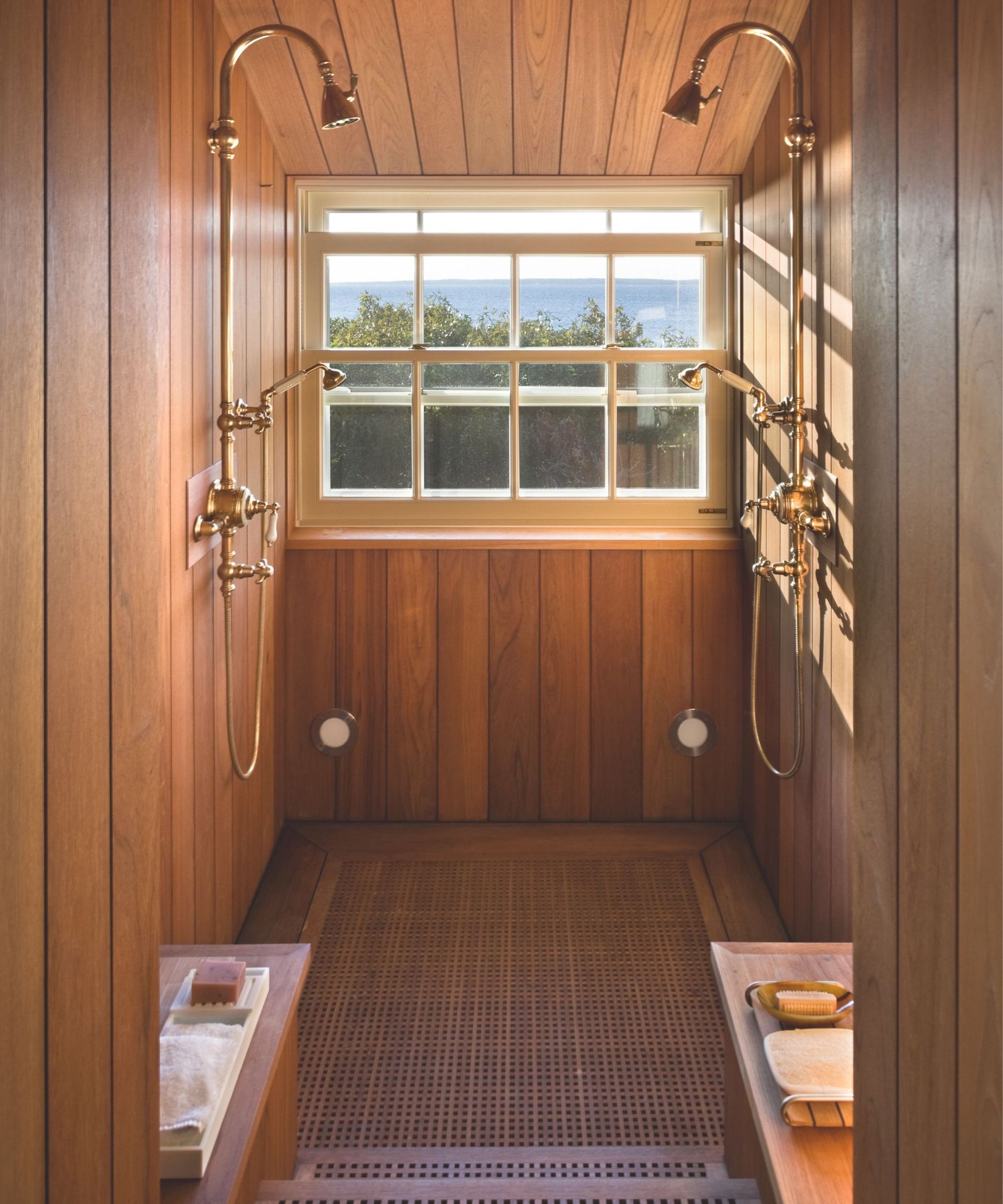 bathroom with wooden surorunds and two showers