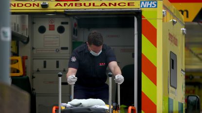 A paramedic moves a stretcher at St Thomas' Hospital, London