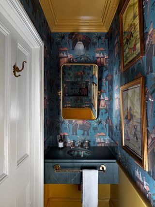 Colorful half bath with bold wallpaper