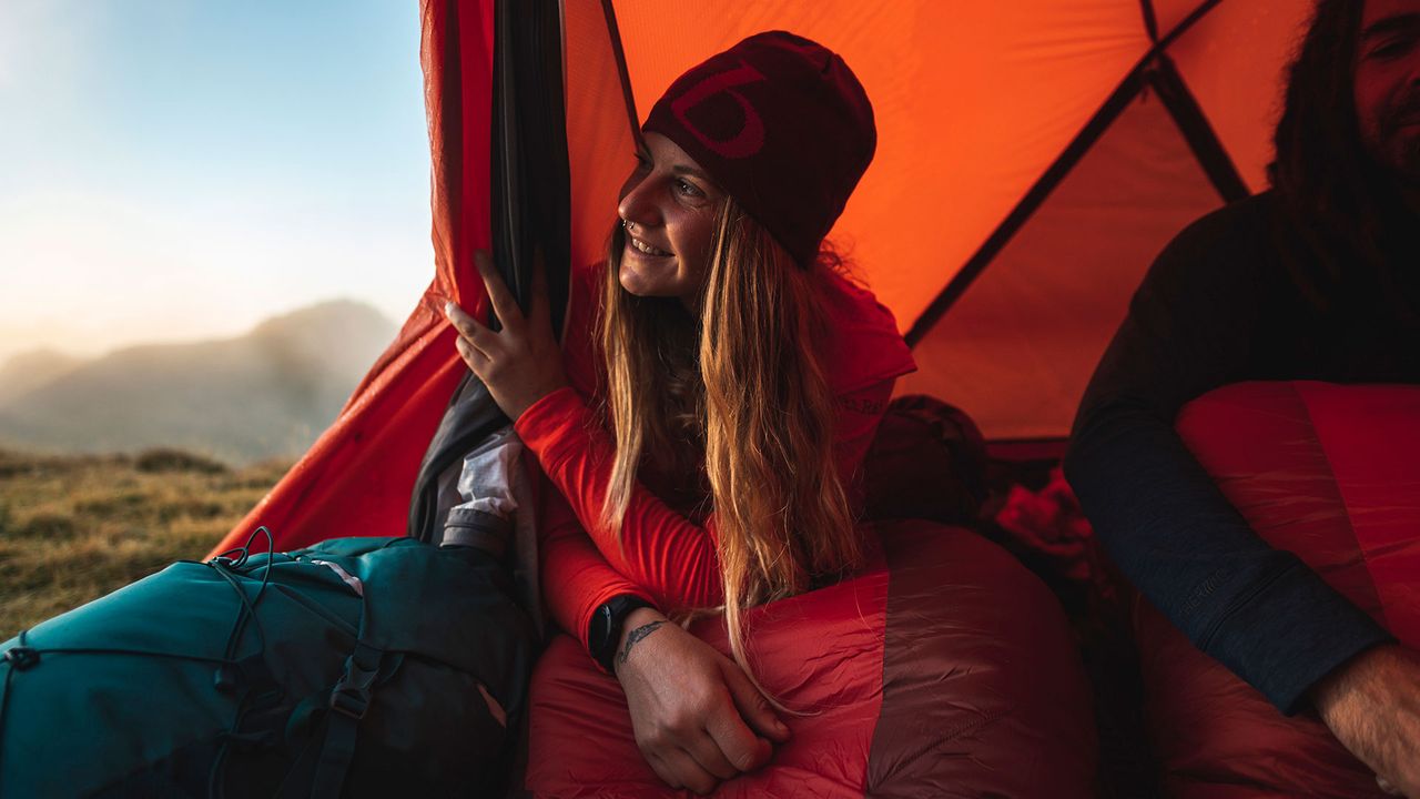 woman in a Rab sleeping bag in a tent