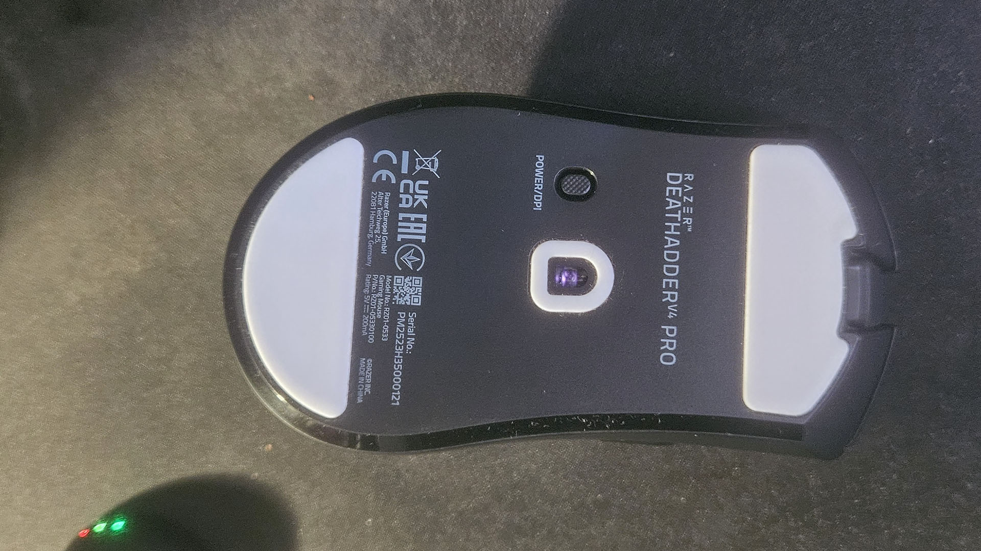 A Razer DeathAdder V4 Pro upside down on a desk