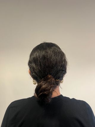 photo of Gabrielle Ulubay from the back with a knotless low bun in her hair