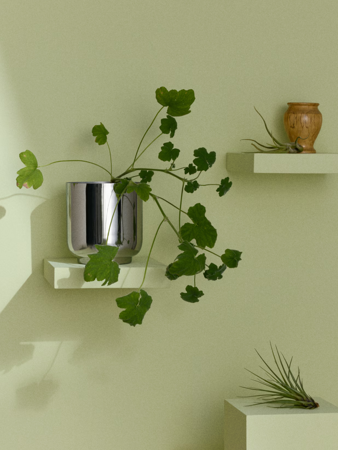A stainless steel plant pot from H&amp;amp;M on a floating shelf