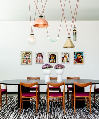 dining room with dark wood chairs and a selection of different pendant lights