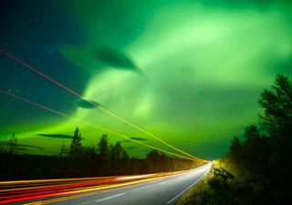 Northern lights with traffic trails long exposure in front