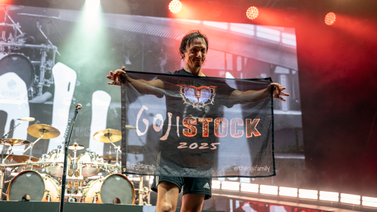 Mario Duplantier holding up a homemade &#039;Goji-stock&#039; flag