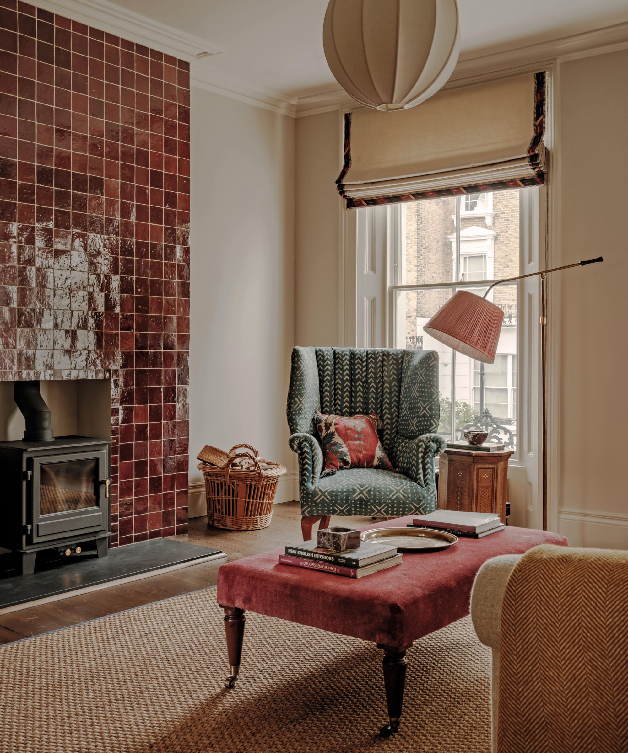 a soft neutral living room with a red zellige tiled chimney breast