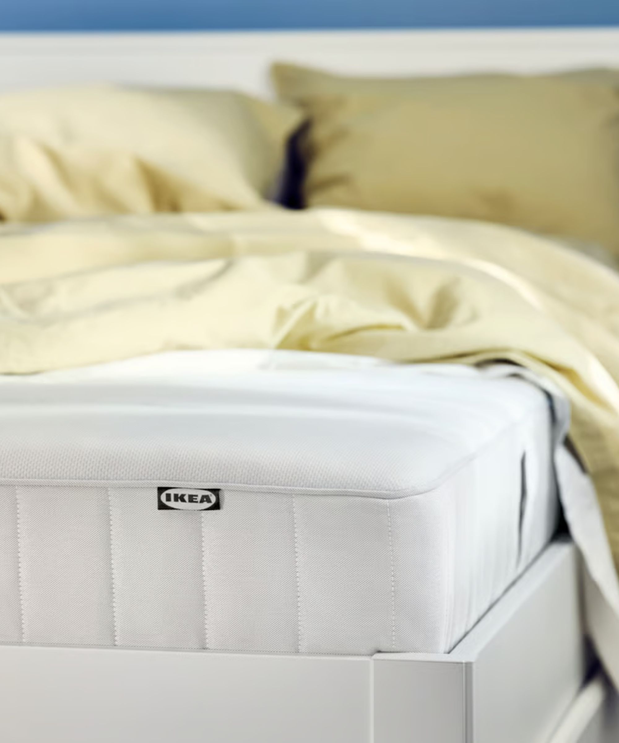 IKEA VESTER&amp;Ouml;Y Pocket spring mattress on a white bed with yellow bedding