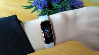 best fitbit Fitbit Luxe with cream band on person's wrist