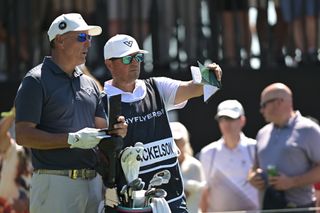 Phil Mickelson chats with his caddie