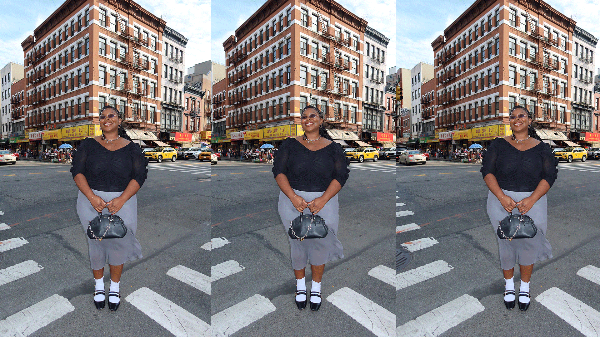 chichi wears black blouse and gray sheer skirt with black top handle coach bag and white socks with black shoes while posing in the streets of NYC