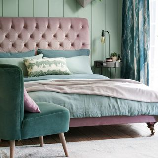 green bedroom with blush pink upholstered bed