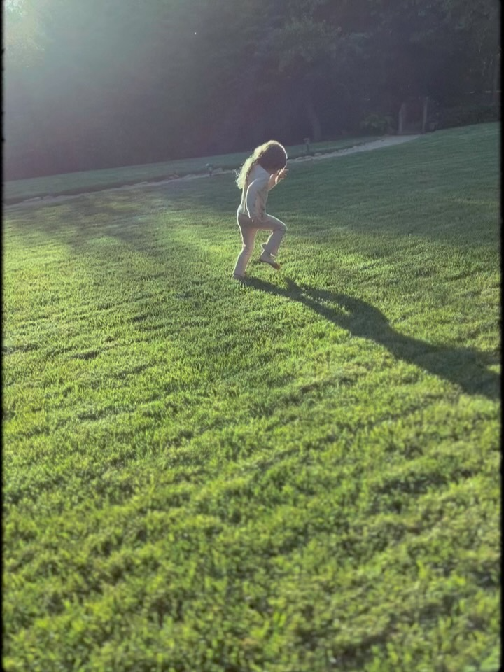 Princess Lilibet running through grass