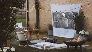 Outdoor movie night garden party theme with projector and screen