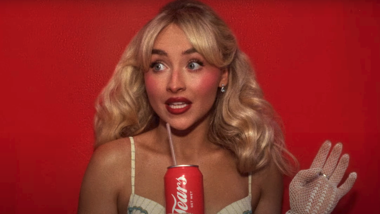 Sabrina Carpenter posing with a Coke style can that says &quot;Tears&quot; while wearing white lingerie in front of a red background in Tears music video
