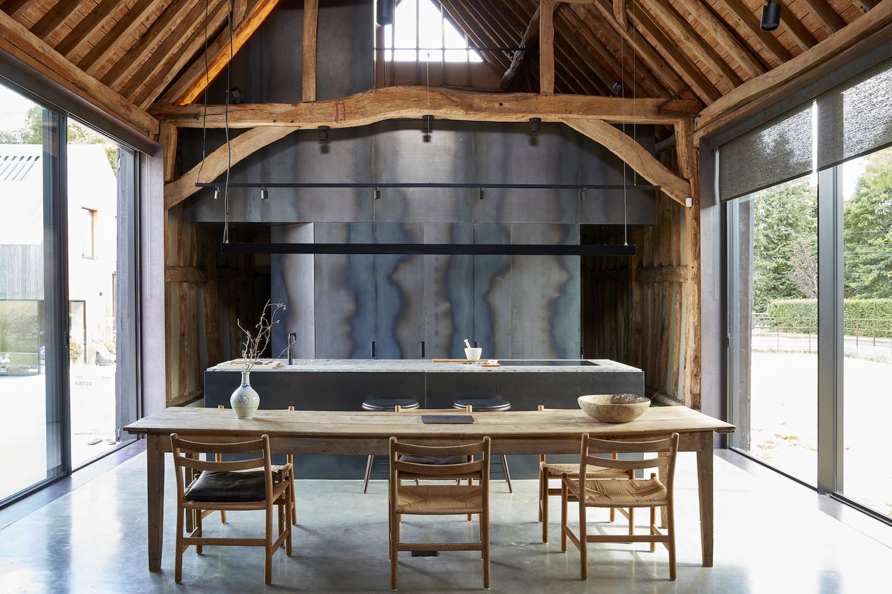 kitchen with black steel units in timber frame barn