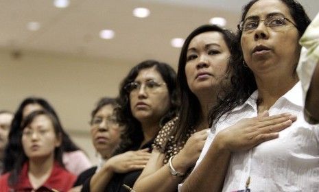 New citizens recite the Pledge of Allegiance. 