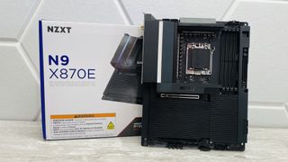 An NZXT N9 X870E motherboard in black with the port covers removed. 