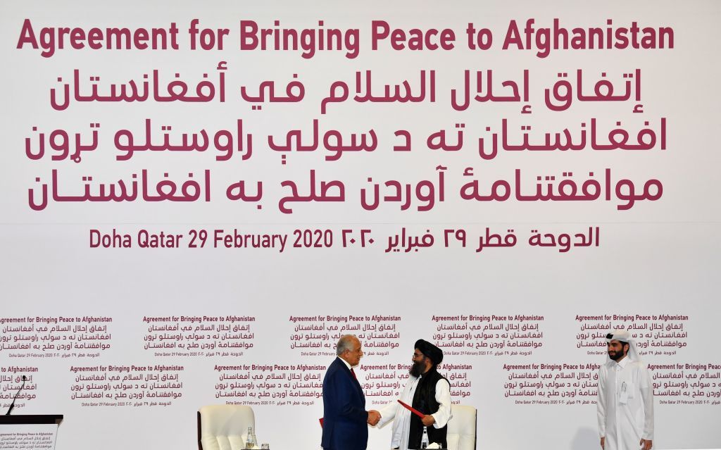 US Special Representative for Afghanistan Reconciliation Zalmay Khalilzad and Taliban co-founder Mullah Abdul Ghani Baradar shake hands after signing a peace agreement.