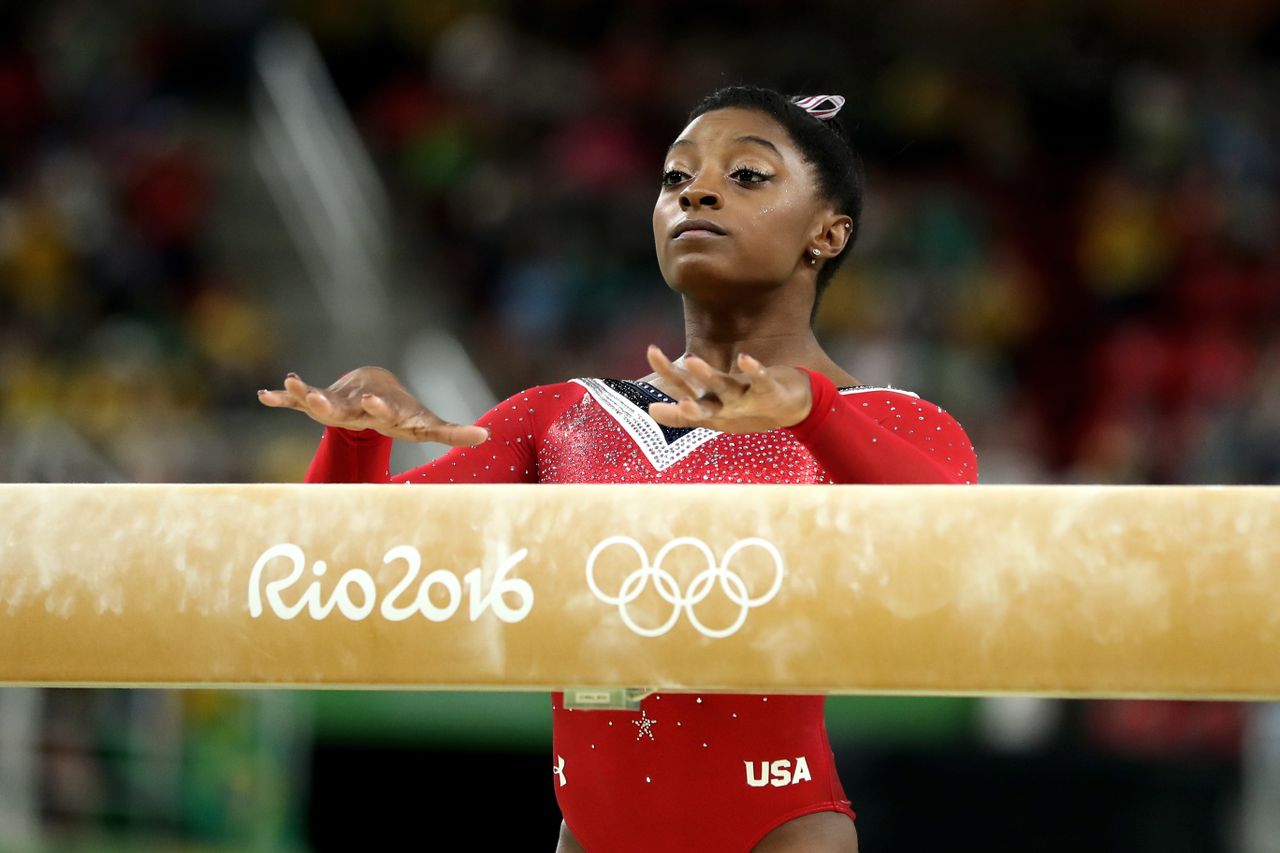 Gymnast Simone Biles prepares to mount the balance beam in Rio