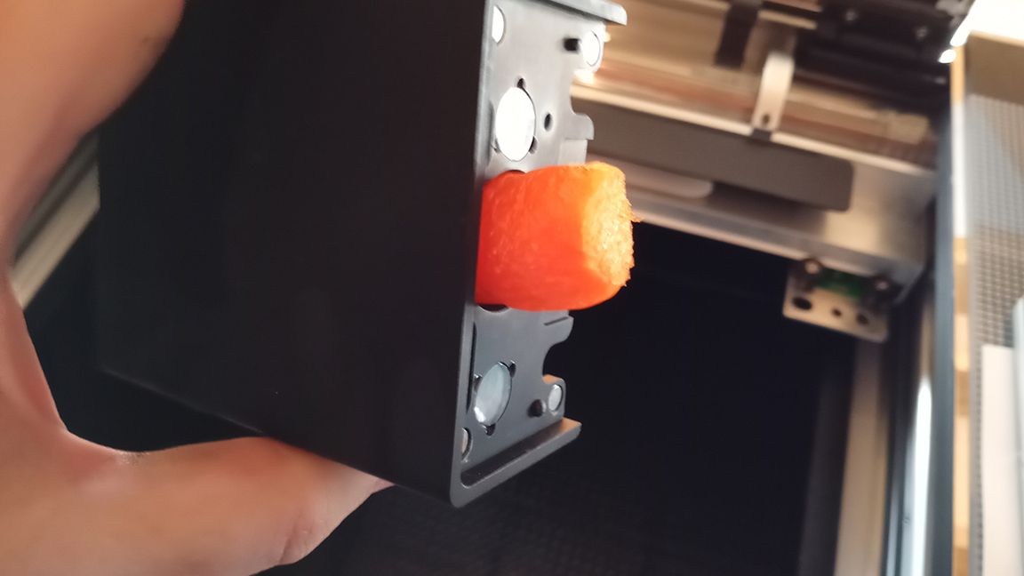 The Glowforge Pro review shows small orange tags and pieces that are used to transport the machine safely