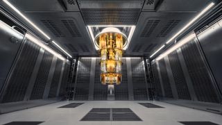 Gold quantum computer hangs from ceiling like a chandelier in a dark room