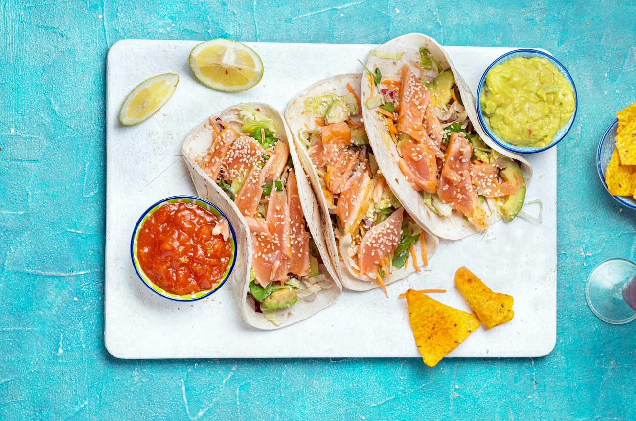 salmon tacos on a board
