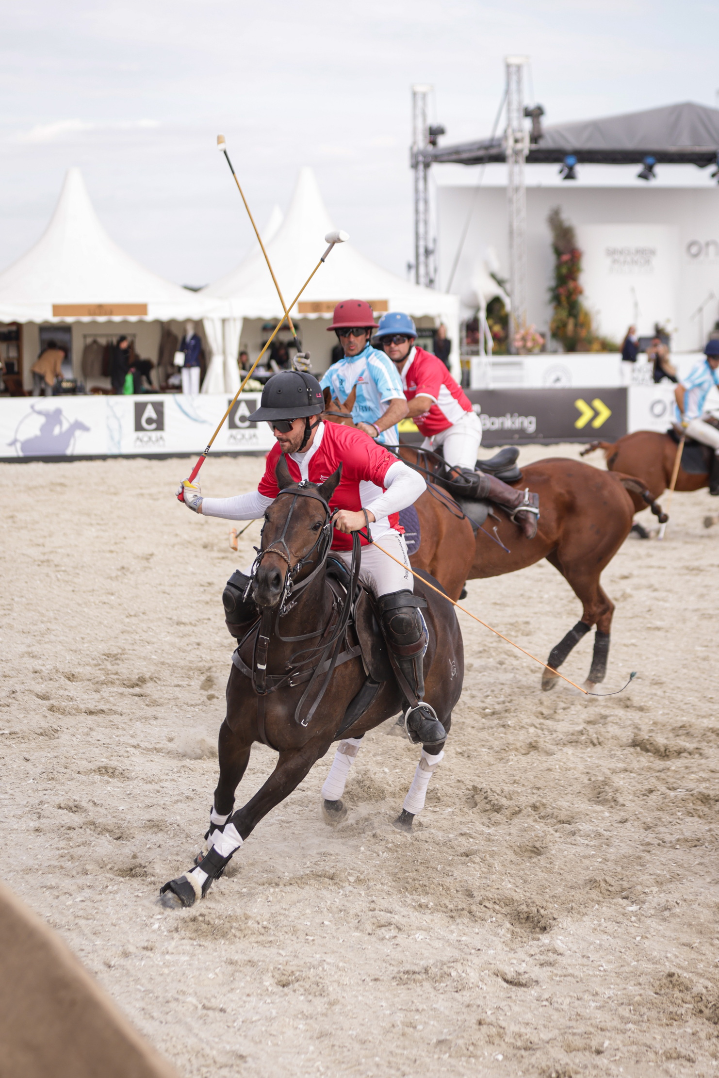 People playing polo on sand