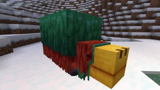 Minecraft Sniffer mob lies in the snow with its legs tucked under its torso