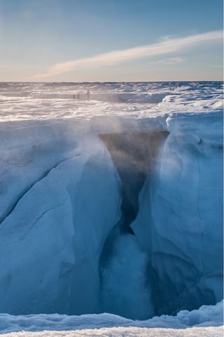 A moulin, or crack, formed along the hydro-fracture through Greenland's North Lake basin continues to drain meltwater to the bed after the 2013 North Lake rapid drainage.