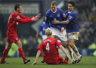 LIVERPOOL, ENGLAND - DECEMBER 11: Sami Hyypia of Liverpool clashes with Duncan Ferguson of Everton during the Barclays Premiership match between Everton and Liverpool at Goodison Park, on December 11, 2004 in Liverpool, England. (Photo by Ross Kinnaird/Getty Images)