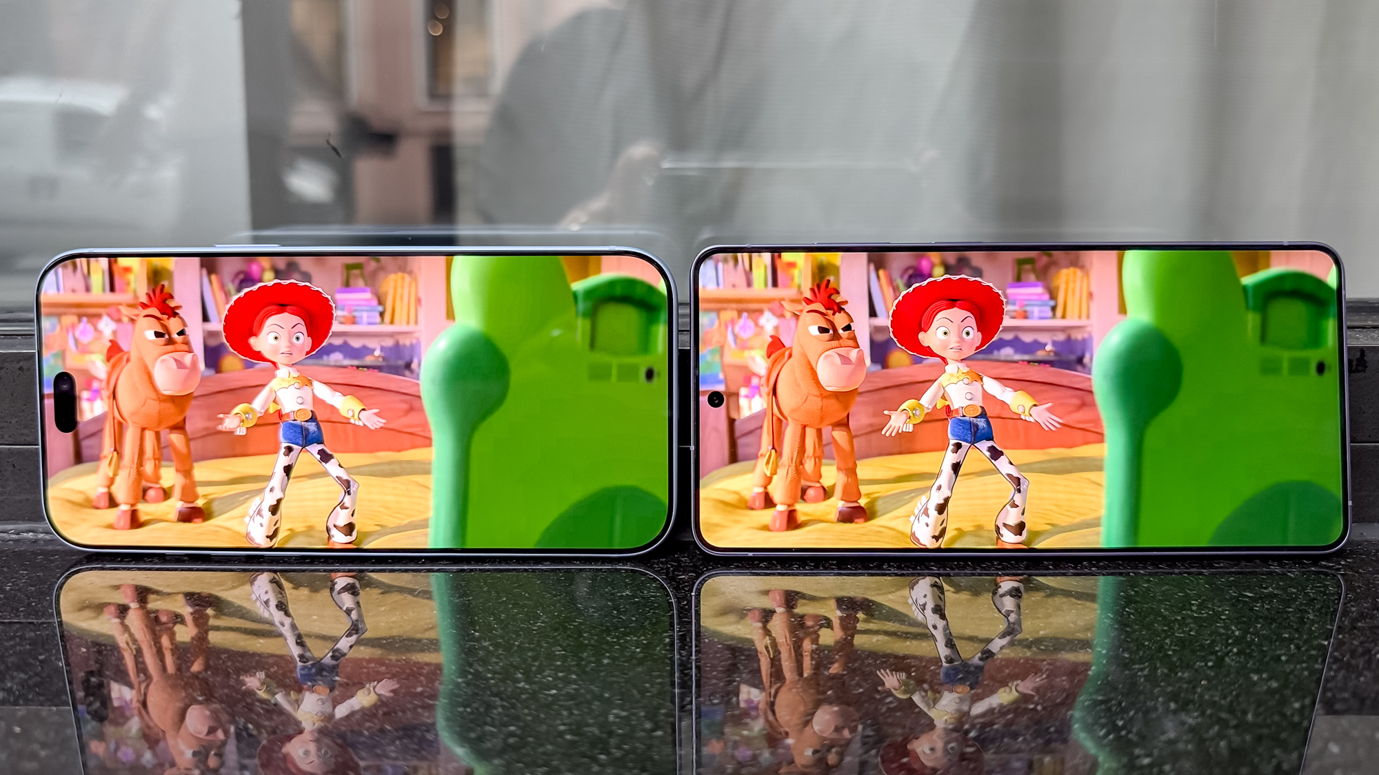 The iPhone 18 Pro Max and Galaxy S26 Ultra side by side showing Toy Story 5 on their displays