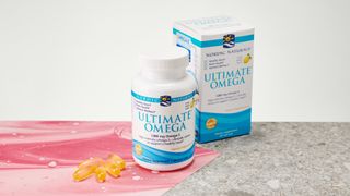 Nordic Naturals Ultimate Omega container, box, and capsules on a table