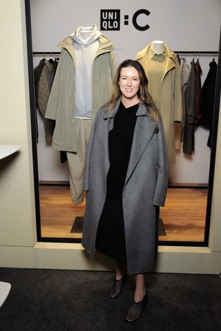 Clare Waight Keller wears a Uniqlo coat and a black dress at a presentation of her brand