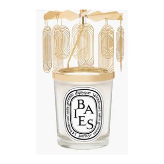 scented candle in glass vessel with gold carrousel attached 