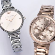A silver Olivia Burton watch with a gold BOSS watch from Chisholm Hunter.
