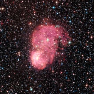 Two festive nebulas, known together as NGC 248, shine as one in this colorful photo captured the Hubble Space Telescope and released by NASA on Dec. 20, 2016. The data to make the image was recorded by Hubble in 2015, NASA says.