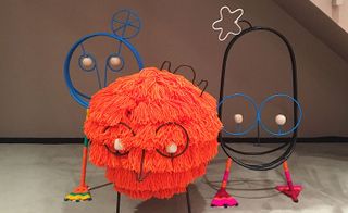 Orange 'Wooly friend' and two metal animal