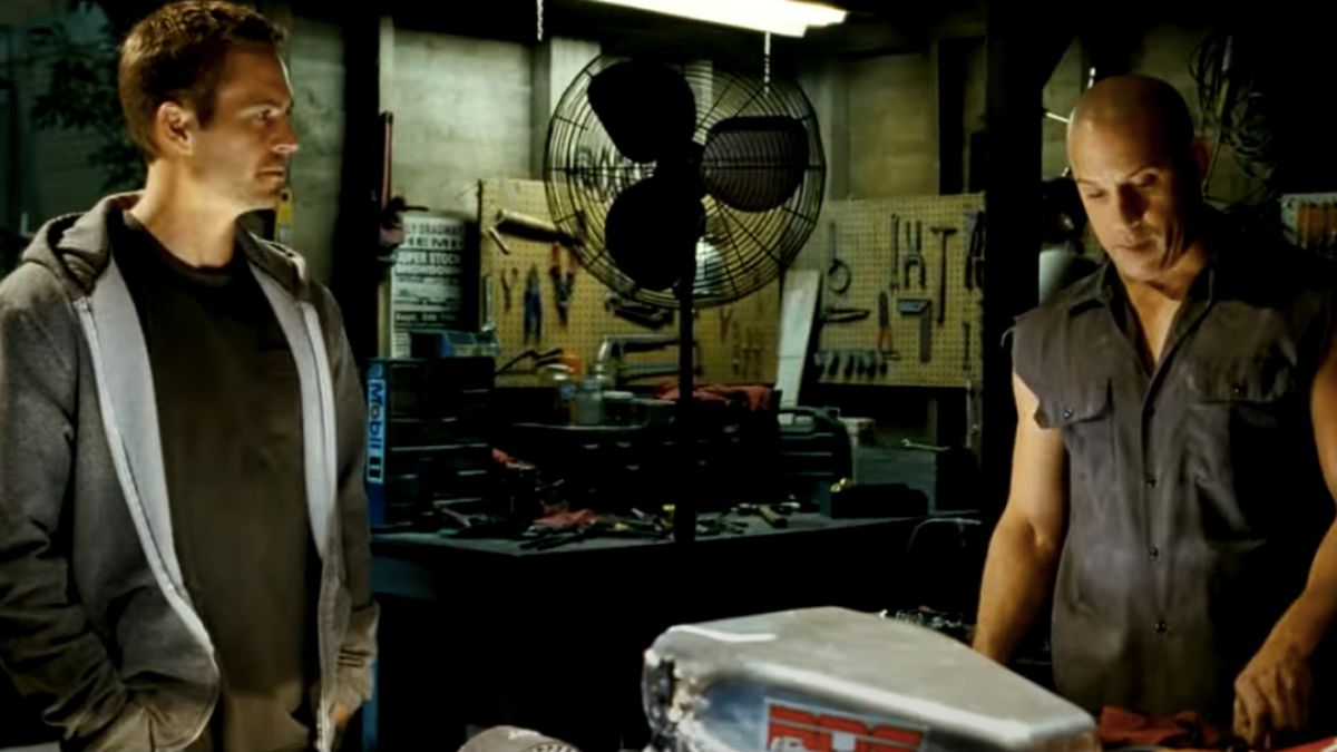 Paul Walker and Vin Diesel have a talk in the garage in Fast &amp; Furious.