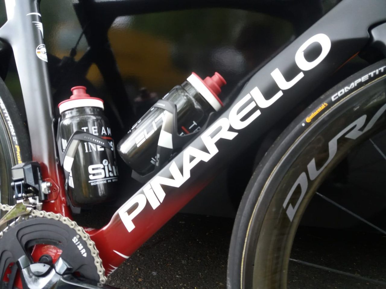 Contrasting Pinarello decals overlay the black and red fade paint design