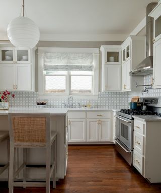 traditional kitchen with white cabinets and wood floors