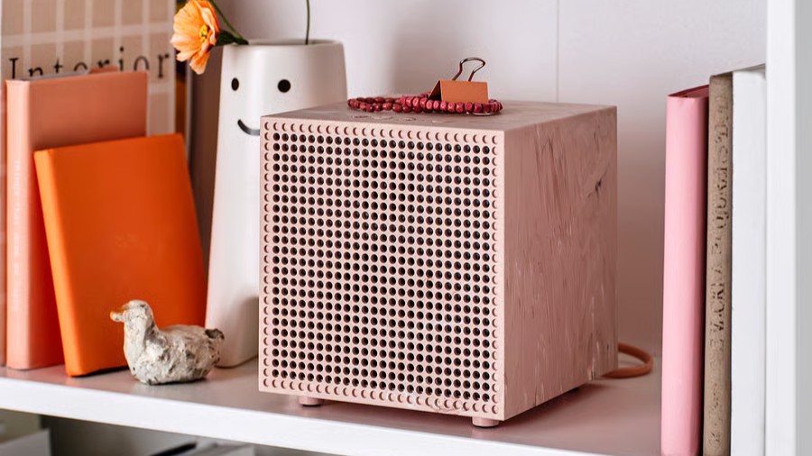 A pink IKEA Badkruka Bluetooth speaker nestled into a shelving unit 