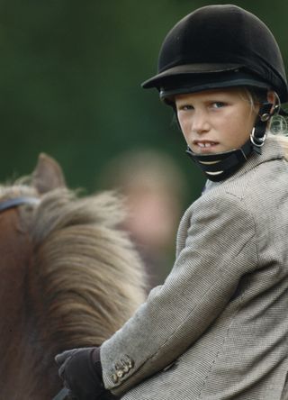 A young Zara Tindall nee Phillips riding a horse