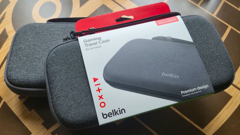 Photo by Rosalie Newcombe of the Belkin Carrying Case sitting on top of the Belkin Charging Case, while both are on a wooden table.